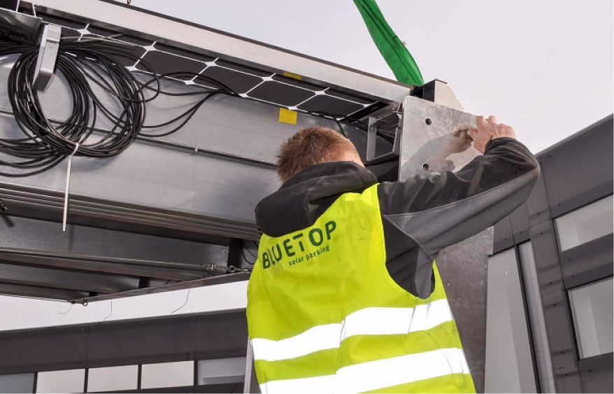 Bluetop Solar Parking employee installing solar carport featuring energy-efficient panels.